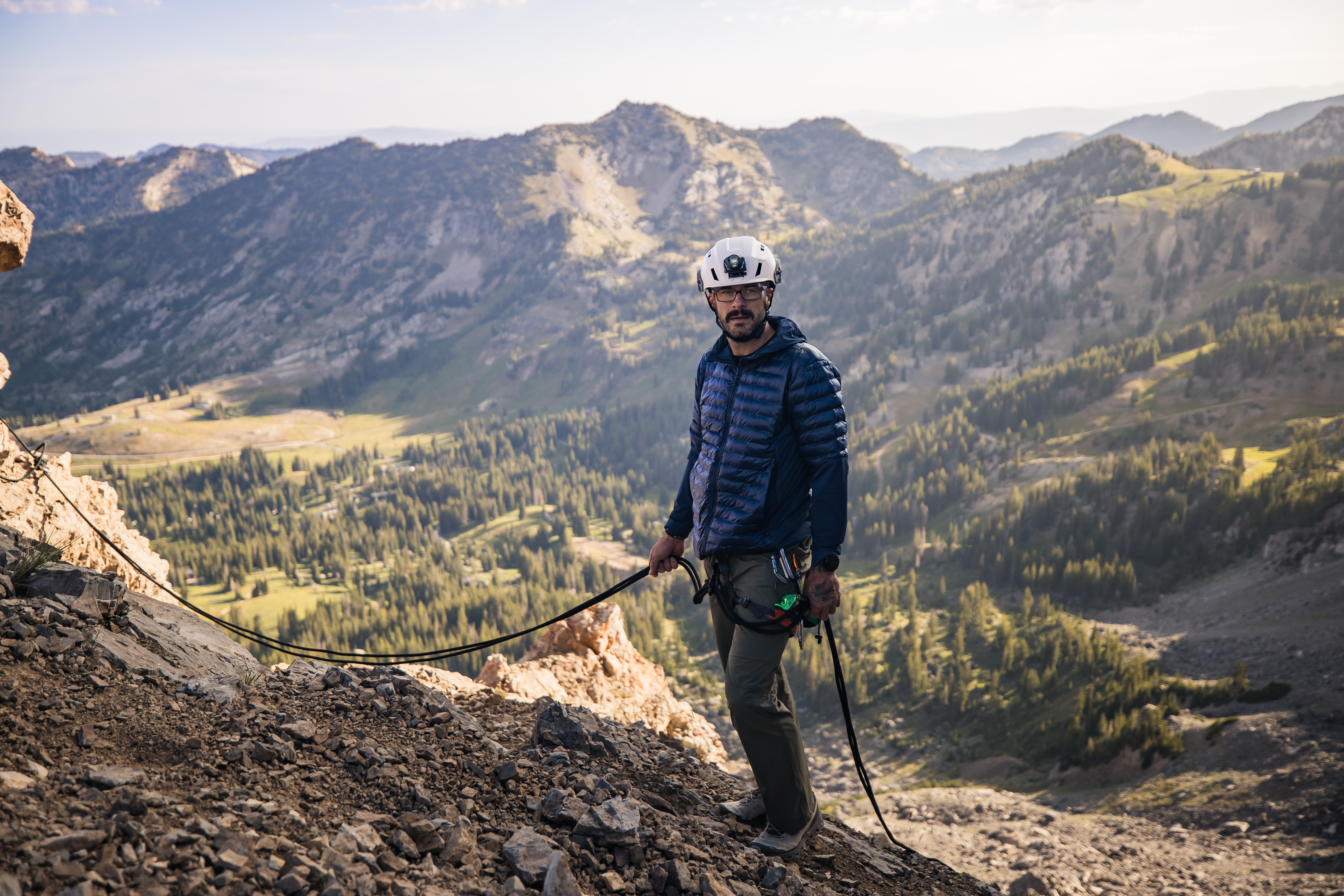 Man with white helmet on holding a rope