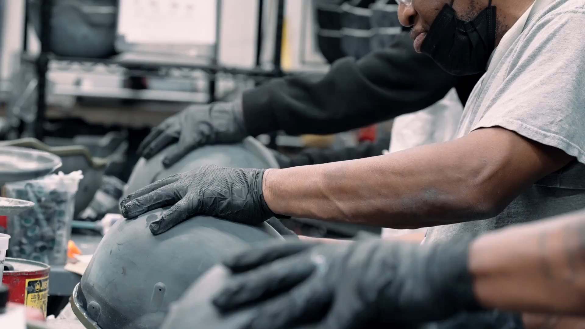 Gloved hands working on manufacturing