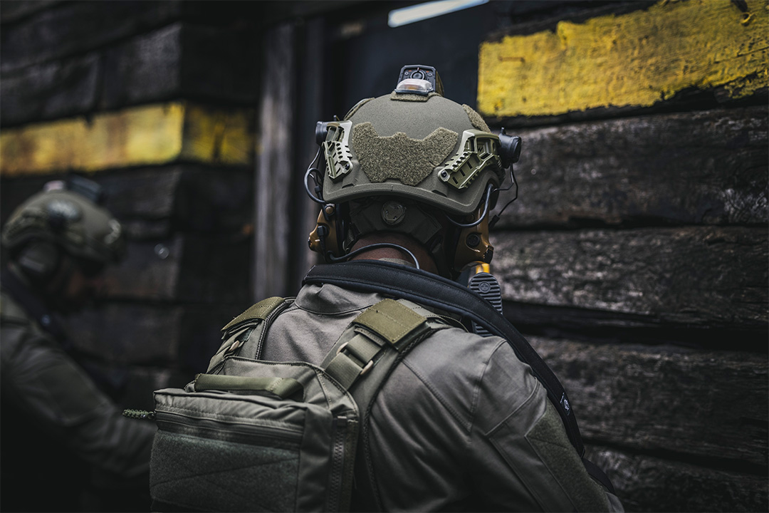 Image of soldier's back with helmet on