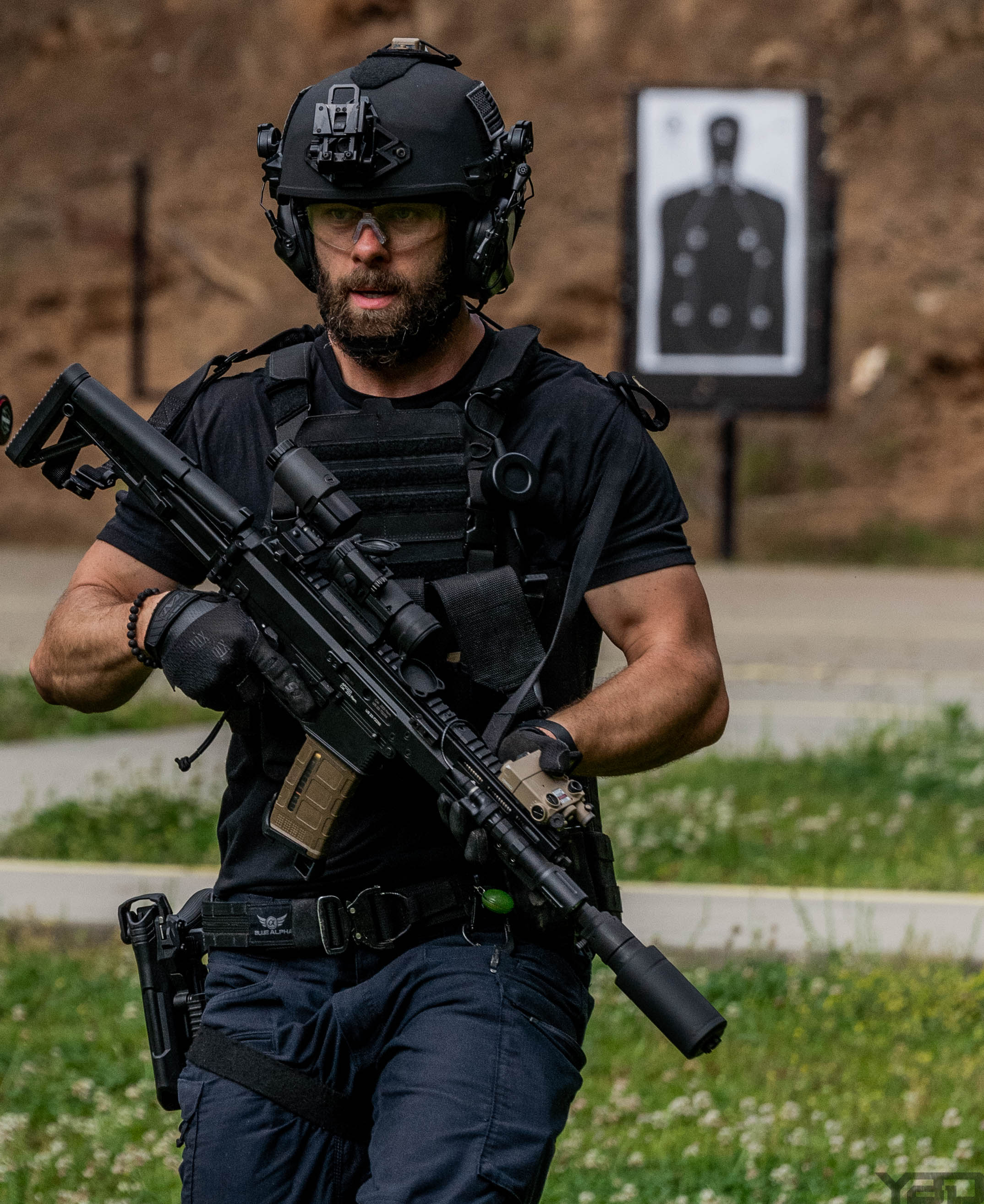 Man wearing a black helmet holding onto gun