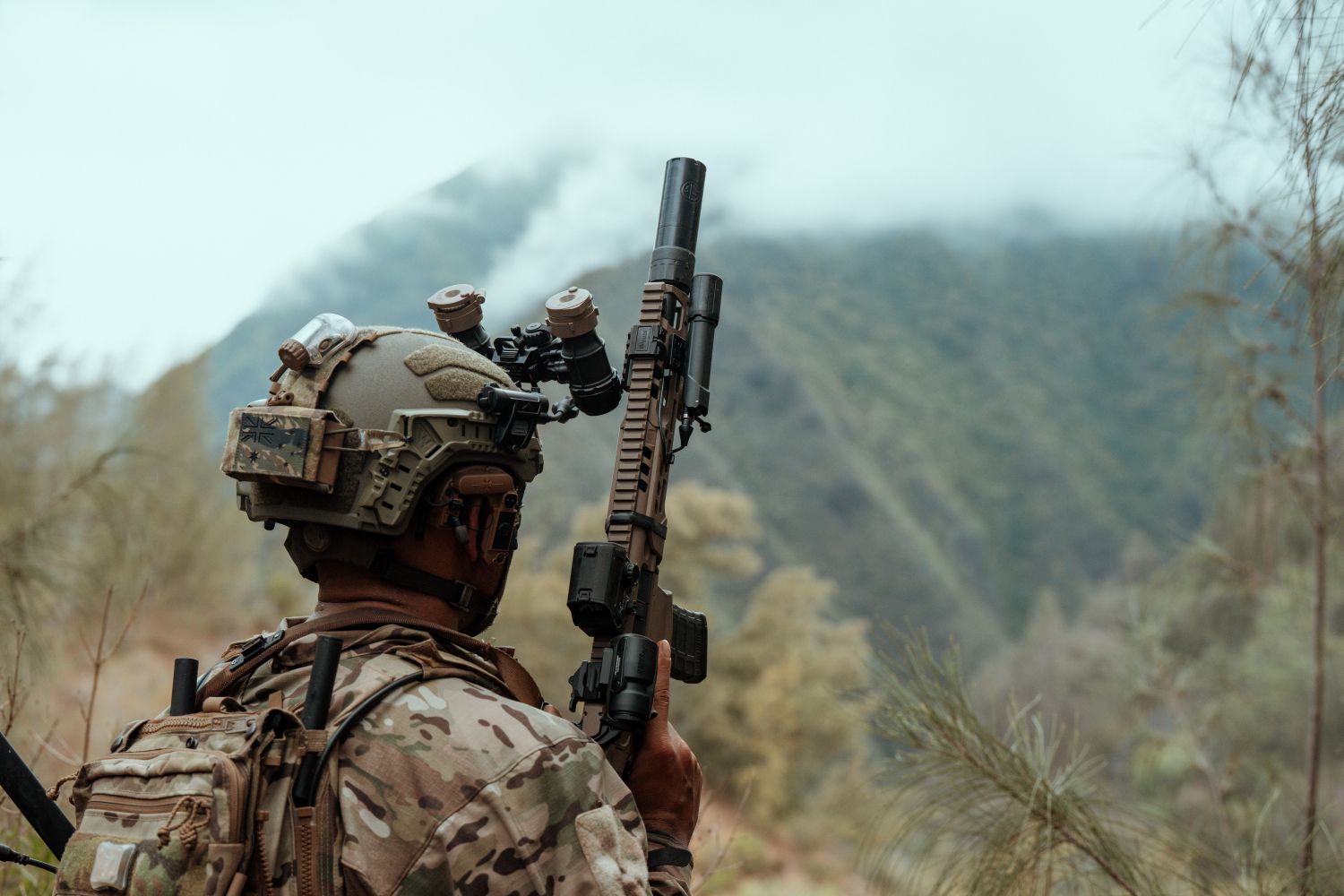 Soldier wearing a Team Wendy RIFLETECH rifle-rated ballistic helmet in a jungle setting